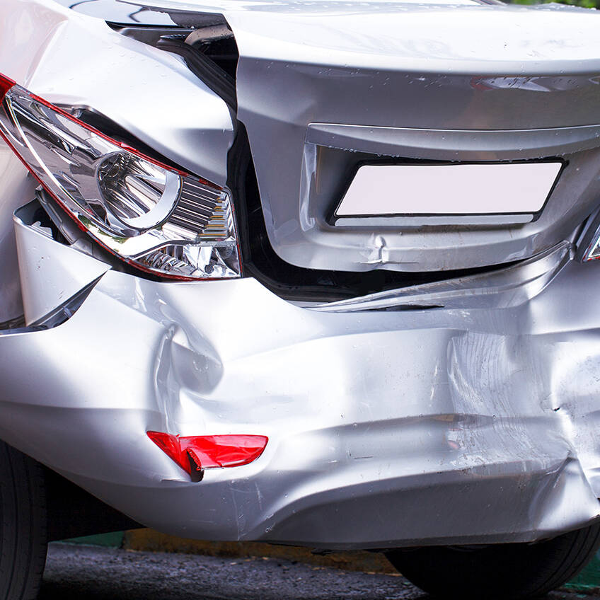 The rear of a car that has major damage from an accident